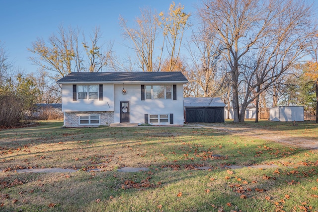 bi-level home with a front lawn and a shed