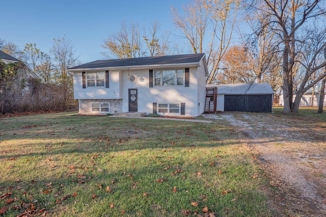 bi-level home with an outdoor structure and a front lawn