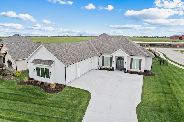 view of front of house with a garage and a front lawn