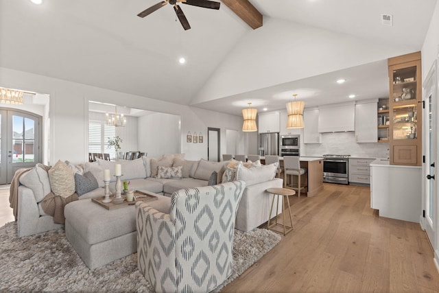 living room featuring ceiling fan, beam ceiling, light wood-type flooring, and high vaulted ceiling