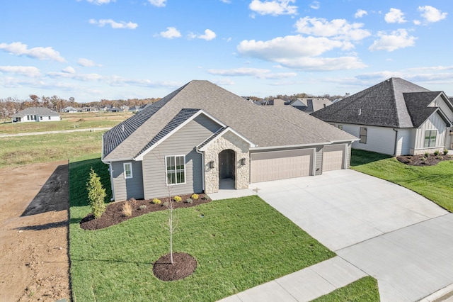 view of front of home with a garage and a front yard