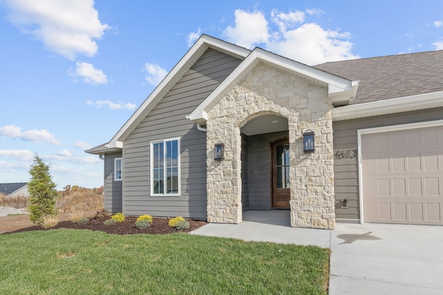 view of front of house with a garage and a front lawn