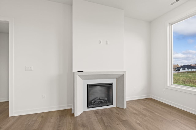 unfurnished living room featuring light wood-type flooring
