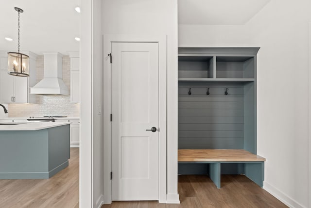 mudroom featuring sink and light hardwood / wood-style floors