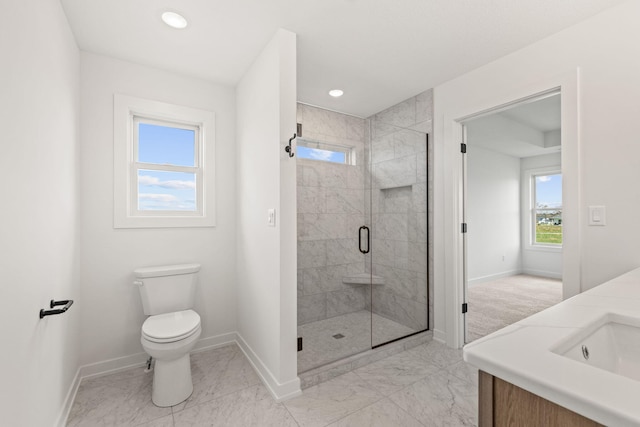 bathroom featuring walk in shower, plenty of natural light, vanity, and toilet