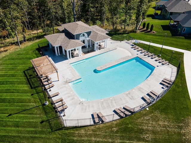 view of pool with a lawn and a patio