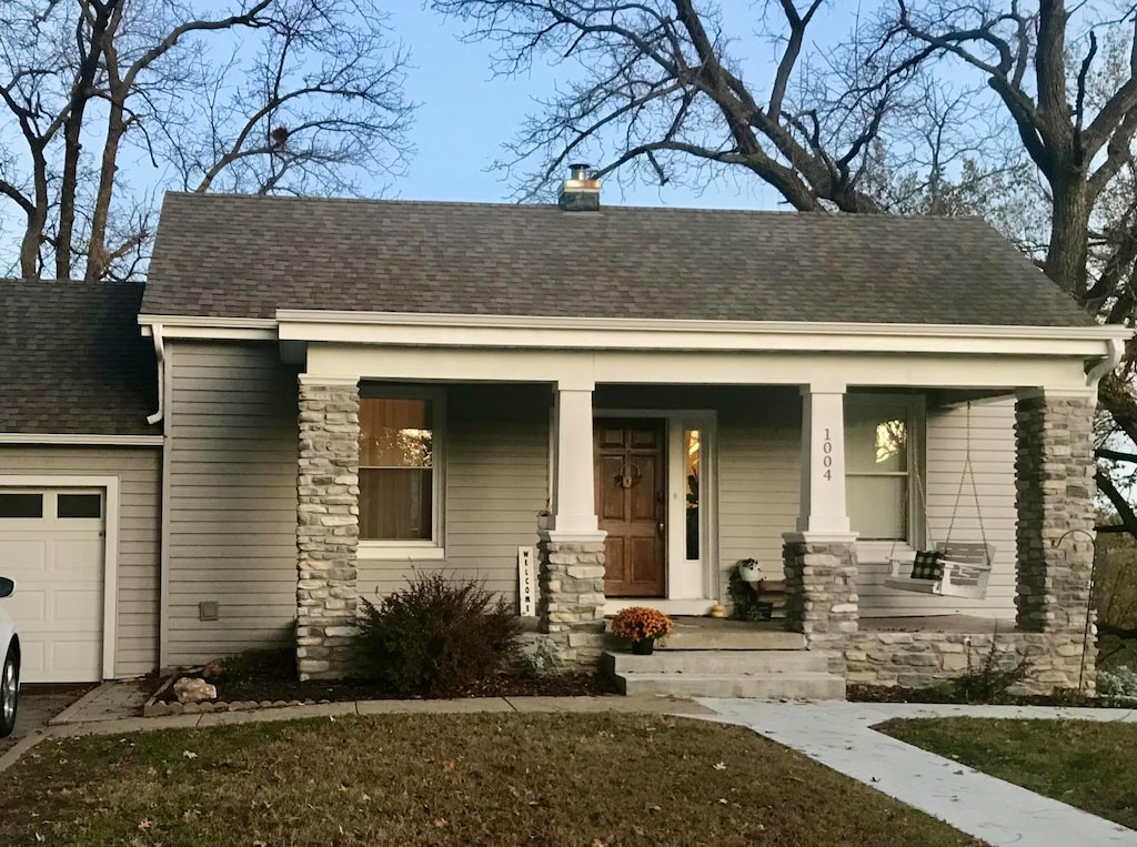 view of front of property featuring a garage and covered porch