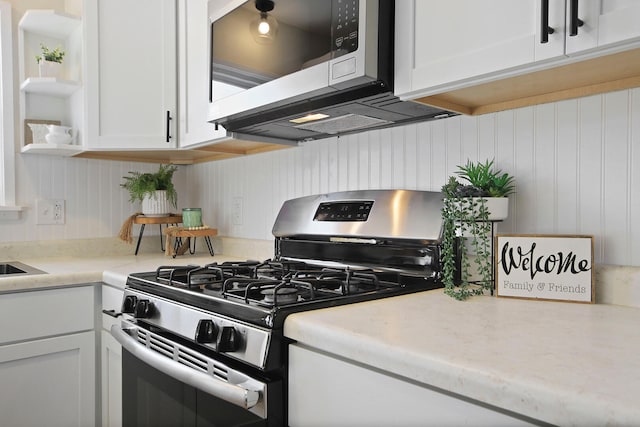 kitchen with appliances with stainless steel finishes and white cabinets