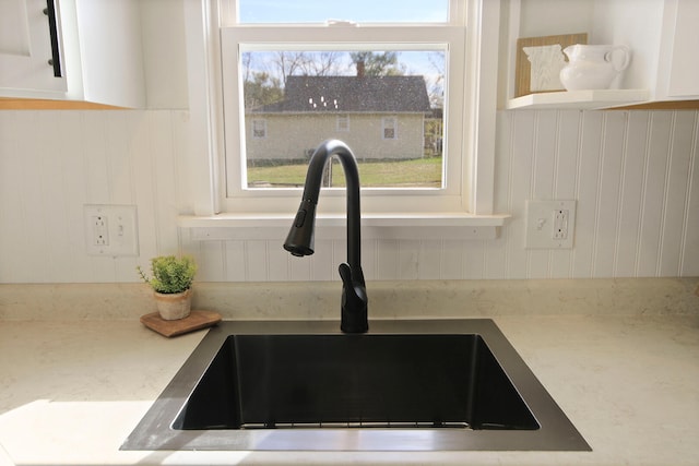 interior details with white cabinets and sink