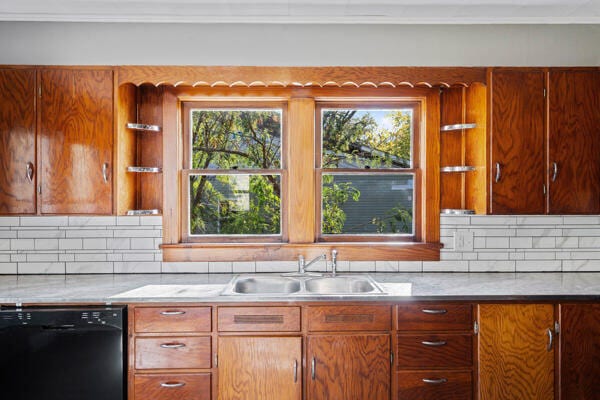 201 N Evans St, Armstrong, MO 65230 - kitchen with black dishwasher, a sink, backsplash, light countertops, and ornamental molding