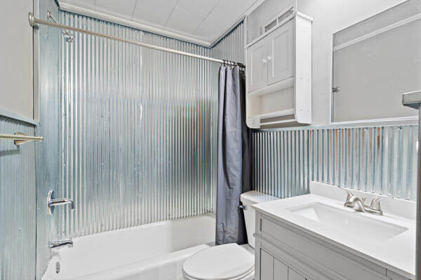 full bathroom featuring vanity, toilet, and shower / bathtub combination with curtain