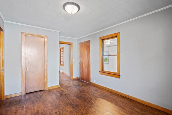 201 N Evans St, Armstrong, MO 65230 - unfurnished bedroom featuring crown molding, wood finished floors, and baseboards