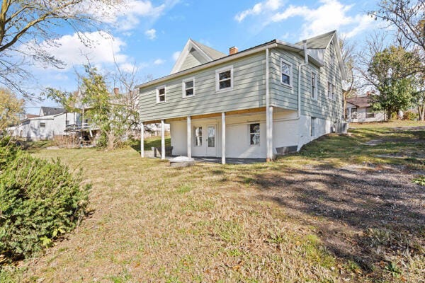 201 N Evans St, Armstrong, MO 65230 - rear view of property with a lawn, a chimney, and a patio