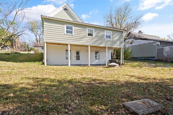 rear view of house with a lawn