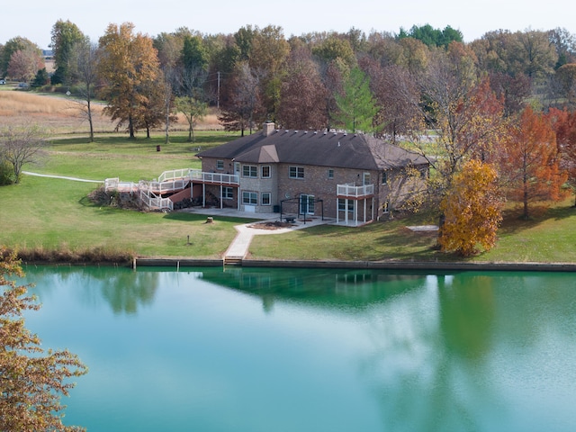 view of swimming pool featuring a water view and a lawn