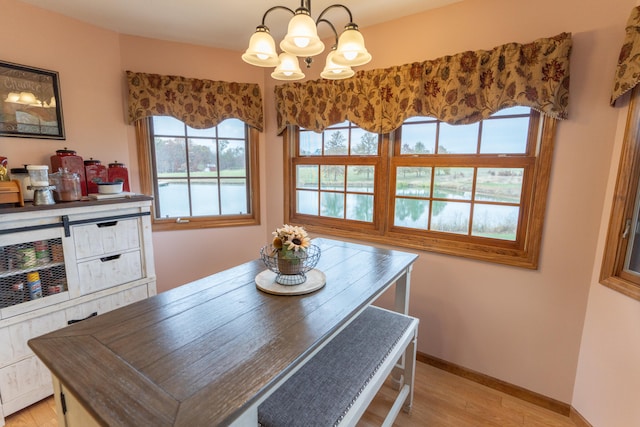 dining area featuring light hardwood / wood-style floors and a notable chandelier