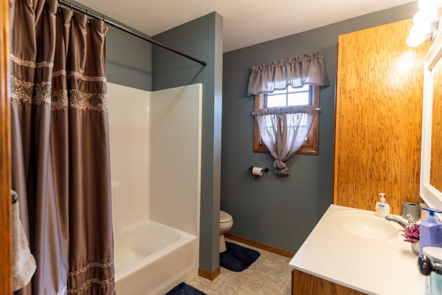 full bathroom featuring tile patterned flooring, vanity, shower / bath combo with shower curtain, and toilet