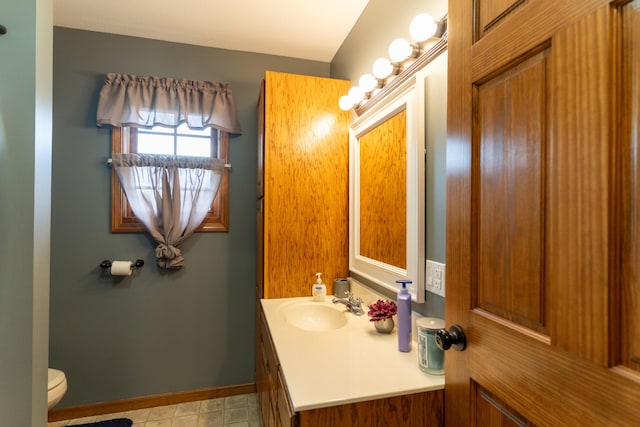 bathroom featuring vanity and toilet