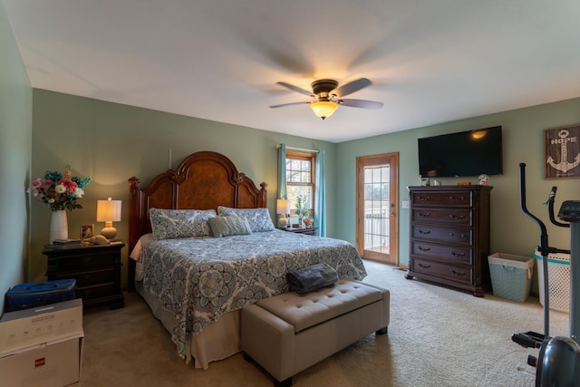 bedroom featuring light colored carpet, ceiling fan, and access to exterior