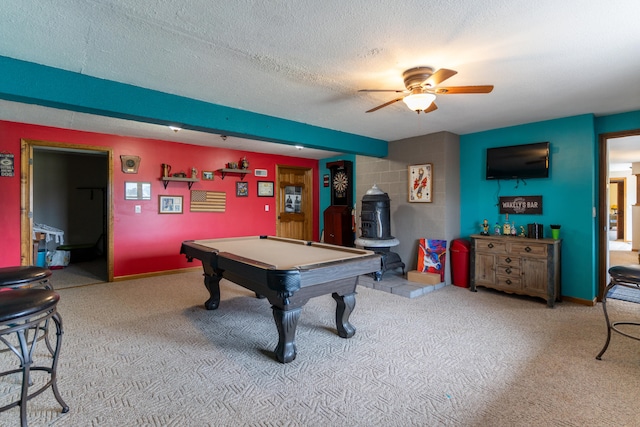 recreation room with a textured ceiling, light carpet, a wood stove, pool table, and ceiling fan