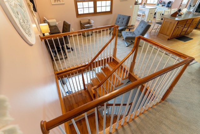 stairway with hardwood / wood-style floors