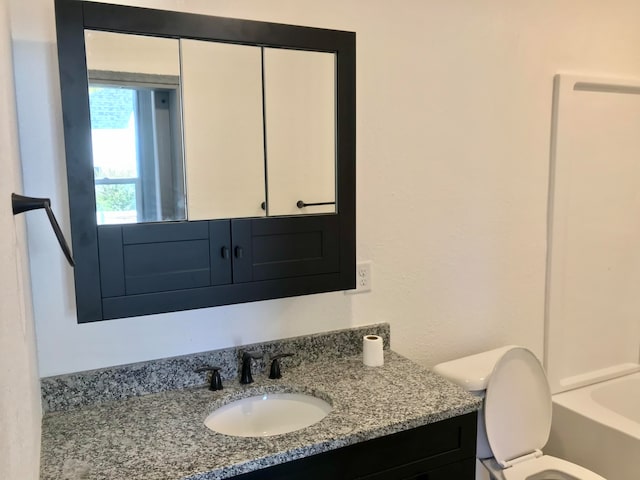 bathroom featuring vanity and toilet