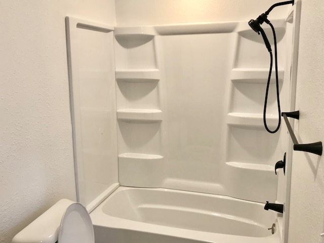 bathroom with bathing tub / shower combination