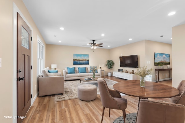 living room with ceiling fan and light hardwood / wood-style floors