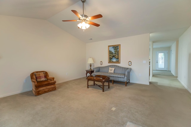 sitting room with ceiling fan, light carpet, and vaulted ceiling