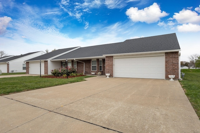 single story home featuring a front yard and a garage