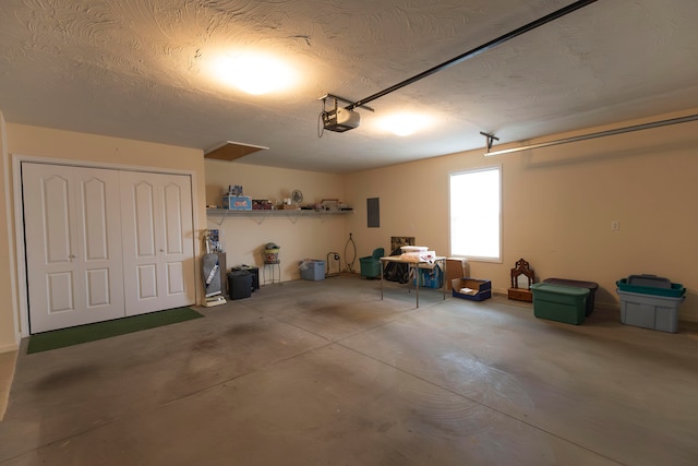 garage with electric panel and a garage door opener