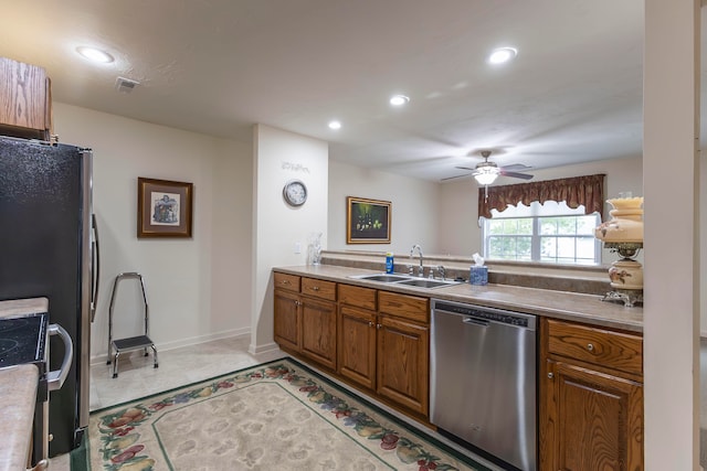 kitchen with stainless steel dishwasher, ceiling fan, and sink