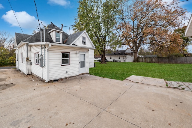 back of house with a yard