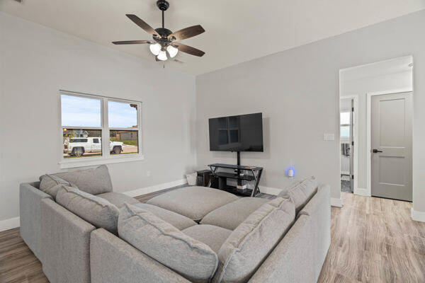 living room with ceiling fan and wood-type flooring