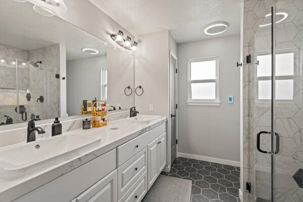 bathroom featuring tile patterned floors, vanity, and walk in shower