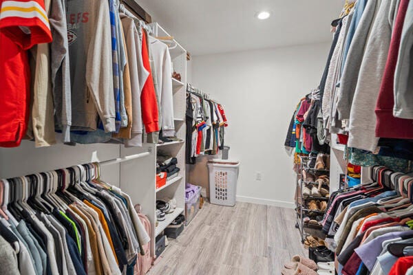 spacious closet with light hardwood / wood-style floors