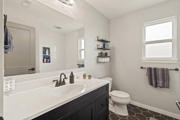 bathroom featuring tile patterned floors, vanity, and toilet