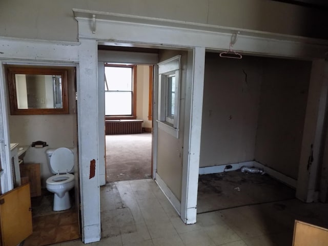 bathroom featuring toilet and radiator heating unit