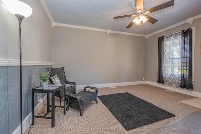 living area with carpet, ceiling fan, and crown molding