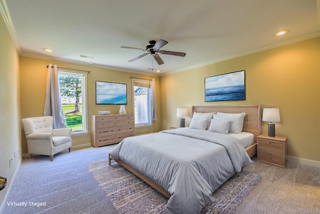 carpeted bedroom featuring ceiling fan and ornamental molding