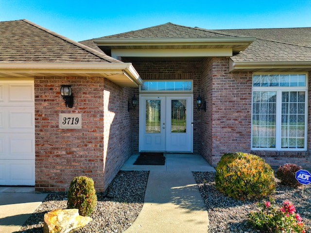 entrance to property featuring french doors and a garage