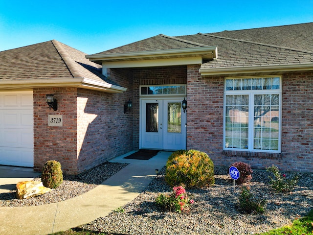 entrance to property featuring french doors and a garage