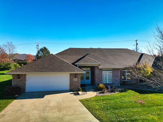 ranch-style home with a garage and a front lawn