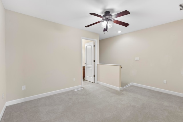 empty room with light colored carpet and ceiling fan