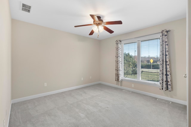 unfurnished room with ceiling fan and light colored carpet