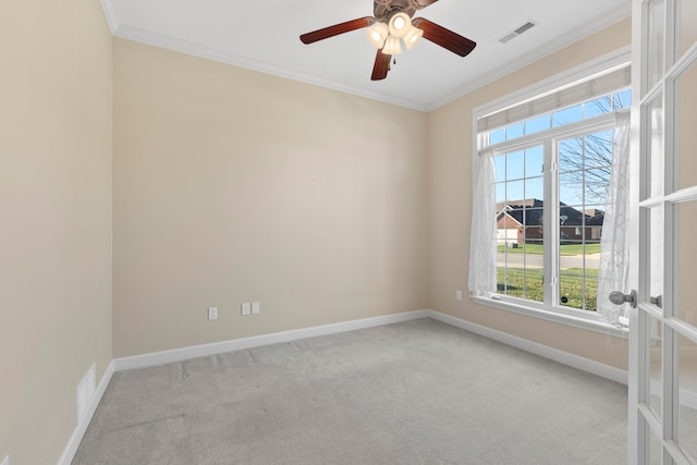 carpeted empty room with ceiling fan and ornamental molding