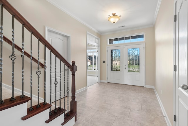 entrance foyer featuring french doors, light tile patterned floors, and crown molding