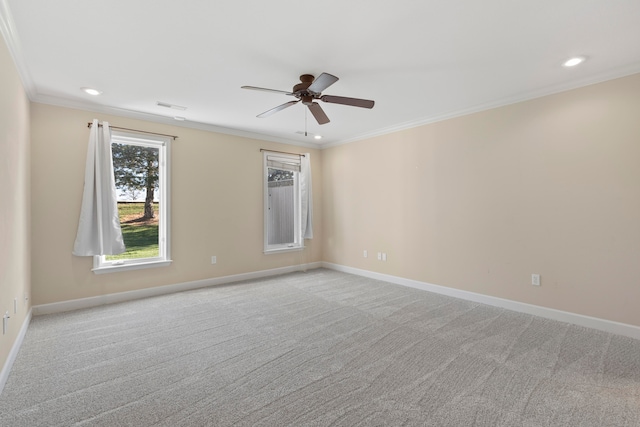 carpeted empty room featuring ceiling fan and crown molding