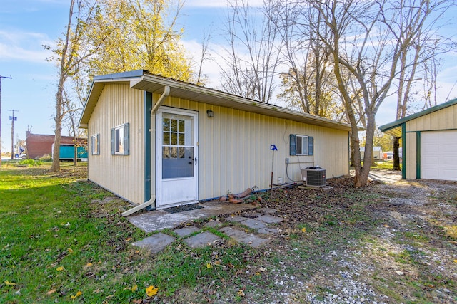 view of home's exterior with central AC, an outdoor structure, and a garage