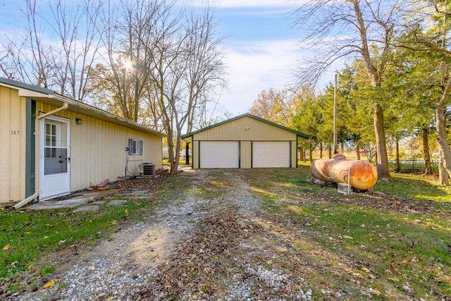 exterior space featuring an outbuilding, central AC, and a garage